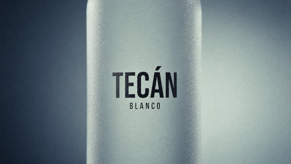 Tecán Blanco — frosted wordmark macro with condensation