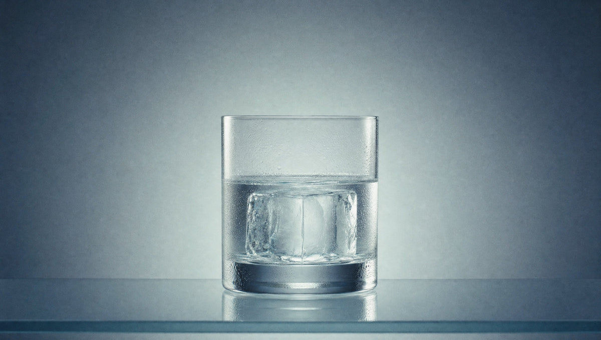Tecán Blanco over a large clear ice cube in a rocks glass